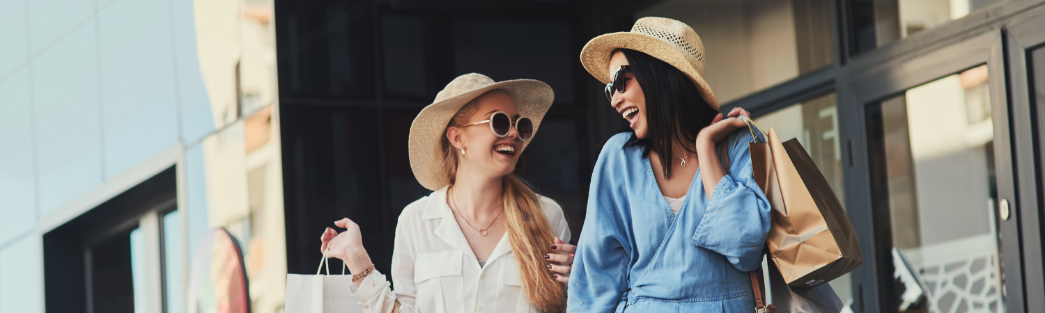 Two girls shopping and laughing. 